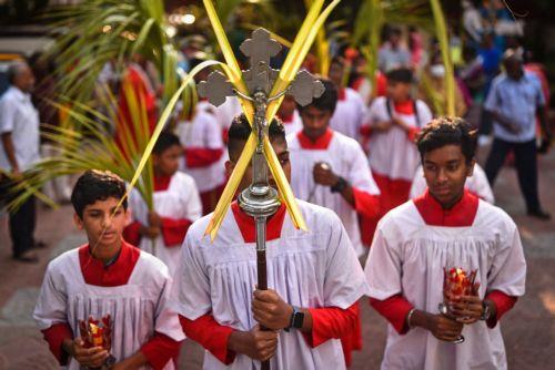 epa10555092 Indian Christians hold palm fronds as they take part in a religious procession on the occasion of Palm Sunday, at a church, in Chennai, India, 02 April 2023. Palm Sunday for Roman Catholic devotees symbolically marks the biblical account of the entry of Jesus Christ into Jerusalem, signaling the start of the Holy Week, prior to Easter. ...