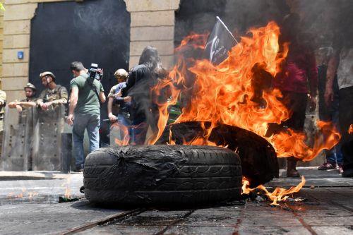 epa10617106 Lebanese Bank customers burn tires outside of the Association of Banks building in Lebanon during a protest against the monetary policies organized by Depositors' Outcry, a group campaigning for the rights of depositors, in Beirut, Lebanon, 09 May 2023. Bank customers demand they be allowed to withdraw their savings, which have been blocked as a...