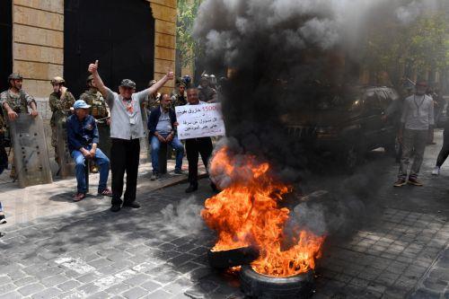 epa10617110 Lebanese Bank customers burn tires outside of the Association of Banks building in Lebanon during a protest against the monetary policies organized by Depositors' Outcry, a group campaigning for the rights of depositors, in Beirut, Lebanon, 09 May 2023. Bank customers demand they be allowed to withdraw their savings, which have been blocked as a...