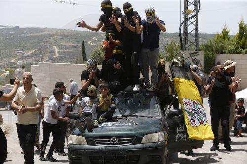 epa10623036 Palestinian protesters during clashes with Israeli troops after a demonstration against Israel's settlements on the lands of Kafr Qaddum village, near the West Bank city of Nablus, 12 May 2023.  EPA/ALAA BADARNEH