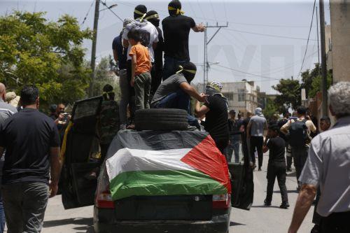 epa10623037 Palestinian protesters during clashes with Israeli troops after a demonstration against Israel's settlements on the lands of Kafr Qaddum village, near the West Bank city of Nablus, 12 May 2023.  EPA/ALAA BADARNEH