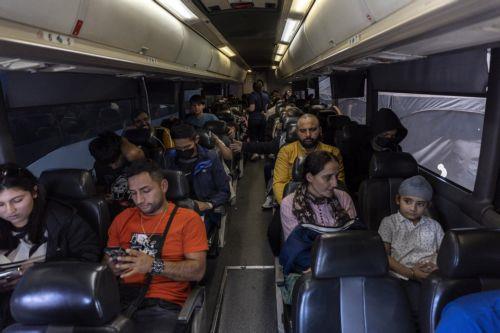 epa10623778 Migrants wait in a bus for its departure to the Phoenix Airport from a migrant transition center after being released by Border Patrol, at the Regional Center for Border Health, in Somerton, Arizona, USA, 12 May 2023. A significant increase in the number of migrants crossing was expected as the Covid-era Title 42 policy, which allowed for a...