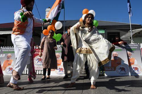 epa10646933 Members of the Indian community in the suburb of Harris Park celebrate in anticipation of a potential visit by India's Prime Minister Narendra Modi to what is known as Little India, in Sydney, Australia, 23 May 2023. Prime Minister Modi has an official engagement tonight with members of the Indian community at Qudos Bank Arena.  EPA/DEAN LEWINS...