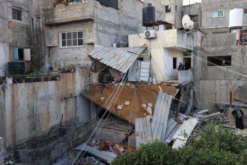 epa10879957 A woman clears rubble from a balcony of a damaged house at the Nur Shams refugee camp near the West Bank city of Tulkarem, 24 September 2023, following a military operation by the Israeli Army earlier the same day. According to the Palestinian Health Ministry, two Palestinians were killed in the raid in which Israeli forces destroyed the main...