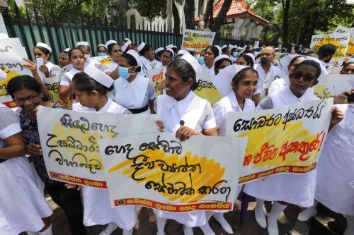 epa10883510 Public sector nurses hold placards as they protest in front of the Ministry of Health in Colombo, Sri Lanka, 26 September 2023. Hundreds of public sector nurses staged a protest in front of the Ministry of Health in Colombo, demanding immediate answers to medicine and medical equipment shortages, resolving the issue of inferior-quality medicine...