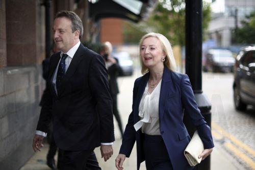 epa10895297 Former British Prime Minister Liz Truss (R) and her husband Hugh O'Leary (L) arrive to address a fringe meeting at the Conservative Party Conference in Manchester, Britain, 02 October 2023. The conference runs from 01 to 04 October at Manchester Central.  EPA/ADAM VAUGHAN