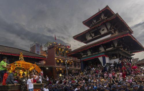 epa10895499 Nepalese people worship a chariot (L) carrying an idol of Lord Ganesh, the god of Beginning, on the last day of the Indra Jatra festival at the Basantapur Durbar Square in Kathmandu, Nepal, 02 October 2023. The eight-day-long Indra Jatra festival is held in honor of Indra, the king god of heaven and the god of rains, as well as to honor family...