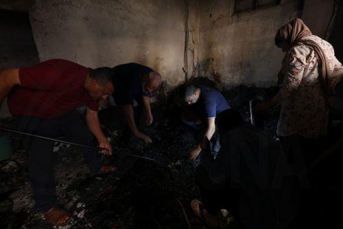 epa10968317 Palestinians inspect the damage inside a burnt house at the Jenin refugee camp following an Israeli raid, near the West Bank city of Jenin, 10 November 2023. According to the Palestinian Health Ministry, at least 14 Palestinians were killed and around 15 others were injured during clashes with Israeli troops. Since 07 October 2023, more than 160...