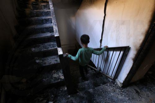 epa10968319 A boy inspects the damage inside his burnt house at the Jenin refugee camp following an Israeli raid, near the West Bank city of Jenin, 10 November 2023. According to the Palestinian Health Ministry, at least 14 Palestinians were killed and around 15 others were injured during clashes with Israeli troops. Since 07 October 2023, more than 160...