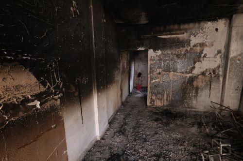 epa10968320 A young girl inspects the damage inside her burnt house at the Jenin refugee camp following an Israeli raid, near the West Bank city of Jenin, 10 November 2023. According to the Palestinian Health Ministry, at least 14 Palestinians were killed and around 15 others were injured during clashes with Israeli troops. Since 07 October 2023, more than...