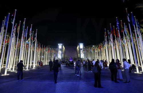 epa11003492 People walk near Al Wasl Plaza's dome at Expo City Dubai, the venue of the 2023 United Nations Climate Change Conference (COP28) in Dubai, United Arab Emirates, 30 November 2023. The 2023 United Nations Climate Change Conference (COP28), runs from 30 November to 12 December, and is expected to host one of the largest number of participants in...