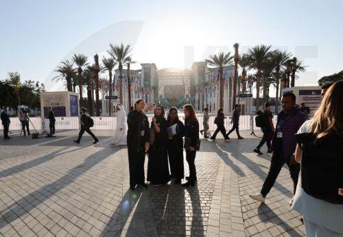 epa11005095 People gather in front of the closed area where global leaders will gather during the 2023 United Nations Climate Change Conference (COP28) at Expo City Dubai in Dubai, UAE, 01 December 2023. The 2023 United Nations Climate Change Conference (COP28), runs from 30 November to 12 December, and is expected to host one of the largest number of...