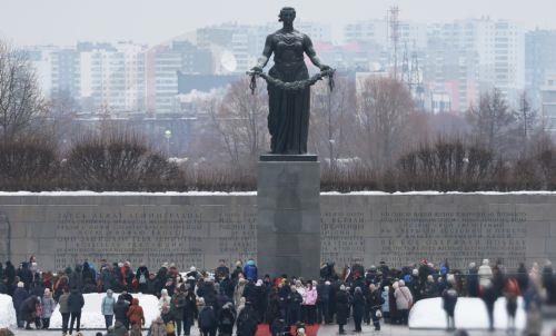 epa11107969 People pay their respects at the Motherland monument at Piskarevskoye Memorial Cemetery as Russian President Vladimir Putin attends a flower-laying ceremony, in St. Petersburg, Russia, 27 January 2024, marking the 80th anniversary of the liberation of Leningrad (Soviet-era name of St. Petersburg) from Nazi blockade in the WWII. Up to 700,000...