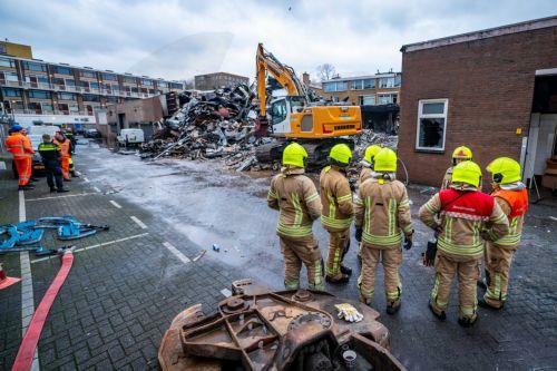 epa11113419 Emergency personnel inspect the damage to and around an apartment complex on Schammenkamp in Rotterdam, The Netherlands, 30 January 2024, the day after a major fire. Several people were injured by an explosion and subsequent fire. The explosion took place underneath the building, which consists of a layer of business units with two residential...