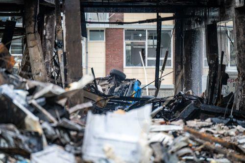 epa11113421 A view of the damage to and around an apartment complex on Schammenkamp in Rotterdam, The Netherlands, The Netherlands, 30 January 2024, the day after a major fire. Several people were injured by an explosion and subsequent fire. The explosion took place underneath the building, which consists of a layer of business units with two residential...