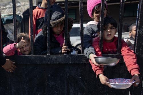 epa11118491 Displaced Palestinian children hold empty pots as they line up to receive food aid provided by a Palestinian youth group, at Rafah refugee camp, southern Gaza Strip, 01 February 2024. Since 07 October 2023, up to 1.9 million people, or more than 85 percent of the population, have been displaced throughout the Gaza Strip, some more than once,...