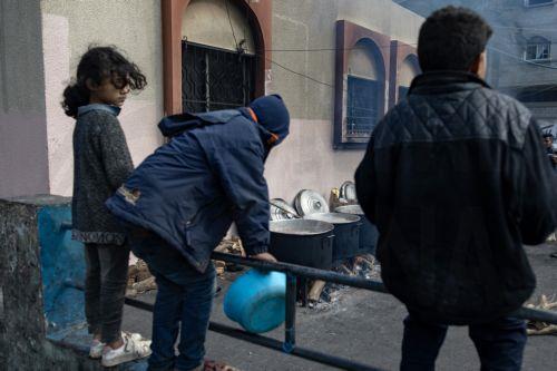 epa11118495 Displaced Palestinian children hold empty pots as they line up to receive food aid provided by a Palestinian youth group, at Rafah refugee camp, southern Gaza Strip, 01 February 2024. Since 07 October 2023, up to 1.9 million people, or more than 85 percent of the population, have been displaced throughout the Gaza Strip, some more than once,...