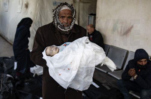 epa11147423 A man holds the body of a baby killed in an Israeli air strike, at Al-Najjar Hospital in Rafah, southern Gaza Strip, 12 February 2024. According to the Palestinian Health Ministry, more than 60 people have been killed and over 230 others have been injured in the airstrikes carried out by the Israeli military. According to a statement released by...