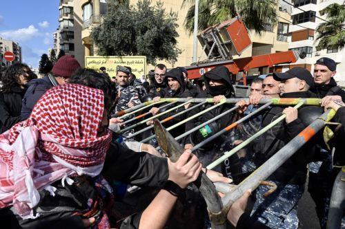 epa11165921 Activists clash with Lebanese riot police during a protest to demand the opening of Rafah border crossing between Egypt and the Gaza Strip, outside of the Egyptian embassy in Beirut, Lebanon, 19 February 2024. Thousands of Israelis and Palestinians have been killed since the militant group Hamas launched an unprecedented attack on Israel from...