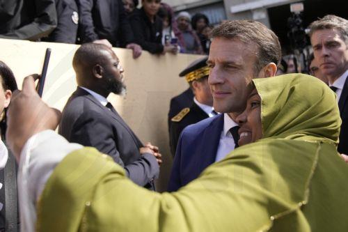 epa11229188 French President Emmanuel Macron (2-R) poses for a selfie with a resident during a visit focused on security and the fight against drug trafficking, in La Castellane, district of Marseille, southern France, 19 March 2024.  EPA/CHRISTOPHE ENA / POOL MAXPPP OUT