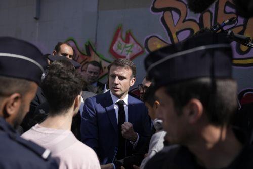 epa11229263 French President Emmanuel Macron (C) meets residents during a visit focused on security and the fight against drug trafficking, in La Castellane, district of Marseille, southern France, 19 March 2024.  EPA/CHRISTOPHE ENA / POOL MAXPPP OUT