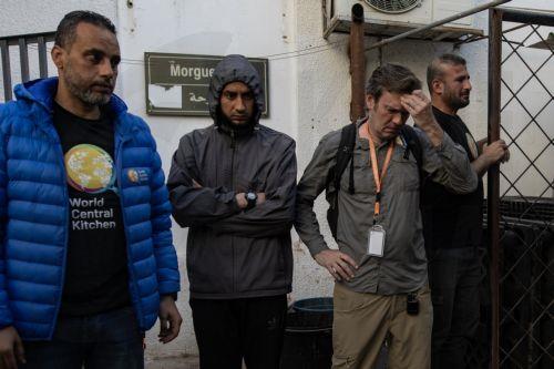 epa11255180 World Central Kitchen workers gather around the bodies of their colleagues after they were transferred to Al-Najjar Hospital in Rafah, southern Gaza Strip, 02 April 2024. NGO World Central Kitchen (WCK) confirmed in a statement on 02 April that seven of its members were killed in an Israeli strike, when a missile hit their convoy in Deir al...