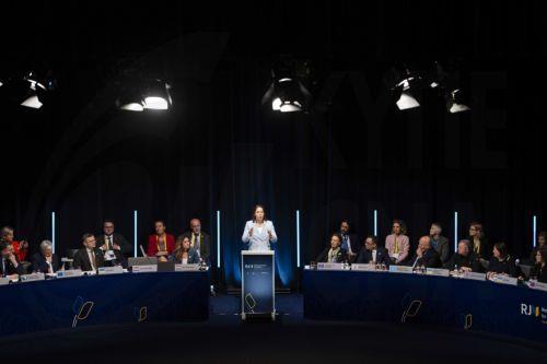 epa11255278 Dutch Minister of Foreign Affairs Hanke Bruins Slot (C) addresses the delegates via a video message during an international conference on support to Ukraine in the Hague, the Netherlands, 02 April 2024.  The Netherlands, Ukraine and the European Commission are holding an international conference on the war in Ukraine in the World Forum...