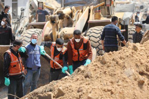 epa11265671 Crew members from the Palestinian ministries of health, justice, and interior work among the rubble searching for possible bodies after the Israeli army had left the Al-Shifa Medical Hospital Complex in Gaza City, 08 April 2024. According to the Israeli army spokesperson, approximately 500 suspects affiliated with Hamas were apprehended and 200...