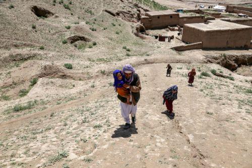 epa11335685 Salim, a 45-year-old man from Baghlan, who lost four of his family members in floods, visits grave of his relatives in Sherjalal village in Baghlan, Afghanistan, 12 May 2024. At least 300 people have died amid heavy floods in Baghlan province in northern Afghanistan, the United Nations Food Program (WFP) said on 11 May. The Asian country is one...