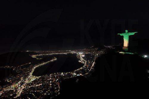 epa11349215 Aerial view of the Christ the Redeemer statue illuminated in green and yellow colors in allusion to the Brazilian soccer team and in celebration of Brazil being chosen to host the Women's Soccer World Cup 2027, in Rio de Janeiro, Brazil, 17 May 2024. The Government of Brazilian President Luiz Inacio Lula da Silva received with 'great...