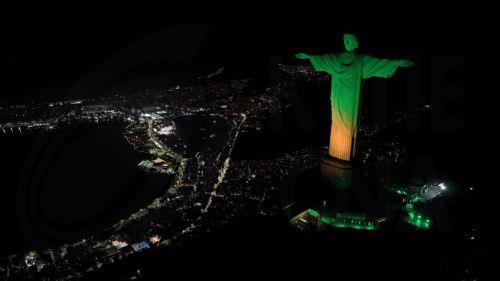 epaselect epa11349218 Aerial view of the Christ the Redeemer statue illuminated in green and yellow colors in allusion to the Brazilian soccer team and in celebration of Brazil being chosen to host the Women's Soccer World Cup 2027, in Rio de Janeiro, Brazil, 17 May 2024. The Government of Brazilian President Luiz Inacio Lula da Silva received with 'great...