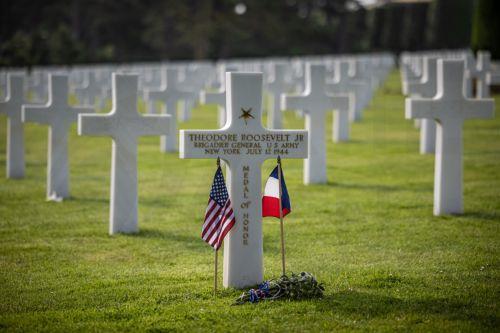 epa11387454 US and French flags are placed on the grave of Theodore Roosevelt Jr., the late military leader and son of American President Theodore Roosevelt, at the American Cemetery ahead of the 80th D-Day anniversary, in Colleville-sur-Mer, Normandy, France, 03 June 2024. World leaders are due to attend memorial events in Normandy, France on 06 June 2024...