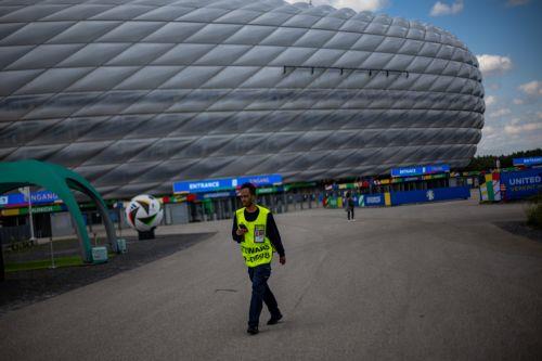 epa11407893 A steward walks outside the Allianz Arena, on the eve of the UEFA EURO 2024 opening match between Germany and Scotland, in Munich, Germany, 13 June 2024. The UEFA EURO 2024 runs from 14 June to 14 July in Germany.  EPA/MARTIN DIVISEK