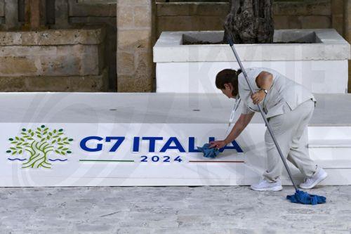 epa11408042 A female worker cleans the platform used for the ritual photos during the welcome ceremony for the G7 summit in Borgo Egnazia, southern Italy, 13 June 2024. The 50th G7 summit will bring together the Group of Seven member states leaders in Borgo Egnazia resort in southern Italy from 13 to 15 June 2024.  EPA/CIRO FUSCO