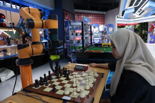 epa11435942 A visitor plays chess with a robotic opponent at a Robotic Park in Jakarta, Indonesia, 25 June 2024. The Indonesian government is encouraging progress in the field of robotics in the country in line with the rapid development of robotic technology supported by developments in artificial intelligence (AI). Indonesia has many educational...