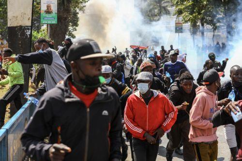 epa11436098 Demonstrators run away from teargas shot by police during a protest against proposed tax hikes, in Nairobi, Kenya, 25 June 2024. Kenya's police on 25 June have sealed off the parliament and State House, and fired tear gas to disperse protesters demonstrating against planned tax hikes that many fear will worsen the cost-of-living crisis. ...