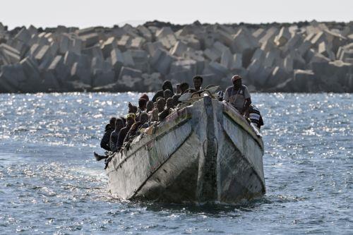 epa11619726 A small wooden boat ('cayuco') carrying some of the 127 sub-Saharan migrants that have been rescued by search & rescue vessel 'Guardamar Caliope' is pictured upon its arrival to La Restinga harbor on El Hierro island, the Canaries, Spain, 22 September 2024.  EPA/GELMERT FINOL