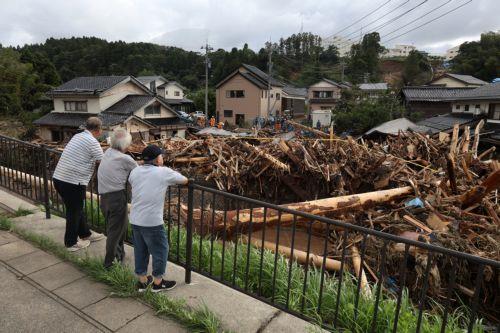 epa11619959 People look at devastation as rescuers search for missing persons in Wajima, Ishikawa Prefecture, Japan, 22 September 2024 (issued 23 September 2024). The Japan Meteorological Agency lifted a heavy rain emergency warning for Suzu, Wajima and Noto towns, keeping the ones for landslides and floods after torrential rain hit the area since 21...