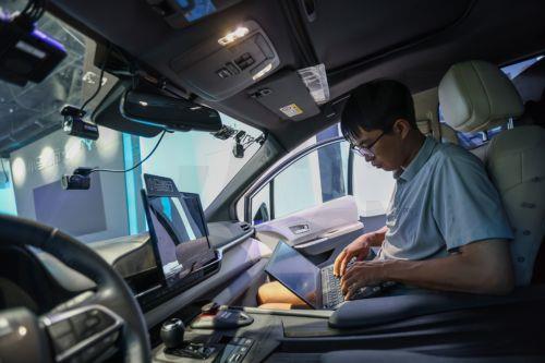 epa11623412 Intelligent vehicle test engineer Jia Binmin shows daily maintenance work to journalists in a self-driving vehicle at Pony.ai operation center in Beijing, China, 21 August 2024 (issued 25 September 2024). China's capital Beijing initiated the autonomous driving demonstration area in September 2020, and approved the commercial operation of fully...