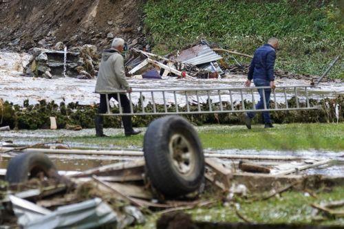 epa11641739 Local residents carry a ladder amidst the debris and damage caused by the flash floods in the village of Trosnjik near Fojnica, Bosnia and Herzegovina, 04 October 2024. Central and southern parts of Bosnia and Herzegovina were hit by a severe rainstorm overnight, which caused widespread flooding, closing roads, cutting electricity, and...