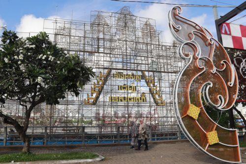 epa11667995 Cambodian people walk past a large boat with installed lights, constructed in preparation for the annual Water Festival celebrations on the Tonle Sap River in Phnom Penh, Cambodia, 19 October 2024. The festival will see boat team from across Cambodia compete in races on the Mekong River. Water festival will run from 14 to 16 November 2024. ...