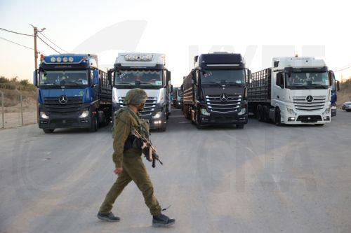 epa11672360 An Israeli soldier walks near Jordanian aid trucks at the Erez crossing on the border with northern Gaza Strip, in southern Israel, 21 October 2024. According to the Israeli Army (Tsahal) and COGAT (Coordination of Government Activities in the Territories), 55 Jordanian aid trucks crossed from Israel into the northern Gaza Strip. In total 200...