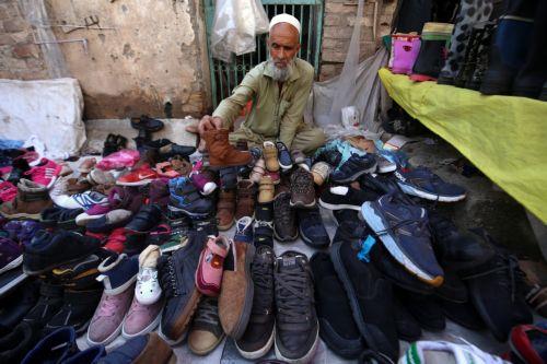epa11679583 A man sells used winter shoes at a roadside market in Peshawar, Pakistan, 24 October 2024. People are increasingly turning to second hand markets for winter wear in response to rising inflation and declining purchasing power. While these markets are known for selling secondhand shoes, they also serve as a source of affordable winter wear across...