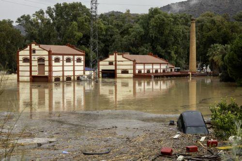 epa11690461 A partially submerged vehicle after the Guadalhorce River burst its banks following torrential rains in Alora, Malaga, Spain, 29 October 2024. The area is currently facing significant rainfall.  EPA/JORGE ZAPATA