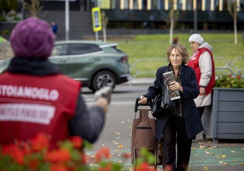epa11694793 A woman walks in a street after she received an electoral newspaper in Chisinau, Moldova, 31 October 2024. Moldova will hold the second round of presidential election, between incumbent Moldovan President Maia Sandu and former prosecutor general Alexandr Stoianoglo, on 03 November 2024.  EPA/DUMITRU DORU