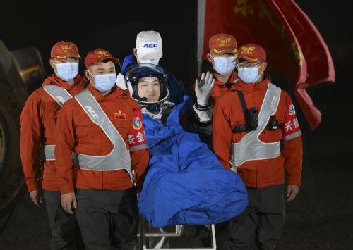 epa11700207 Chinese astronaut Li Guangsu (C) waves as he is carried out of the return capsule of the Shenzhou-18 manned spaceship at the Dongfeng landing site in north China's Inner Mongolia Autonomous Region, 04 November 2024. All three astronauts of the Shenzhou-18 manned mission - Ye Guangfu, Li Cong and Li Guangsu - emerged from the return capsule in...