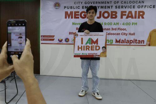 epa11704508 A newly-hired worker poses for documentation at a job fair in Caloocan City, Metro Manila, Philippines, 06 November 2024. Data released on 06 November by the Philippine Statistics Authority showed that the country's unemployment rate in September 2024 decreased to 3.7 percent from 4.0 percent in August 2024. In magnitude, the number of...
