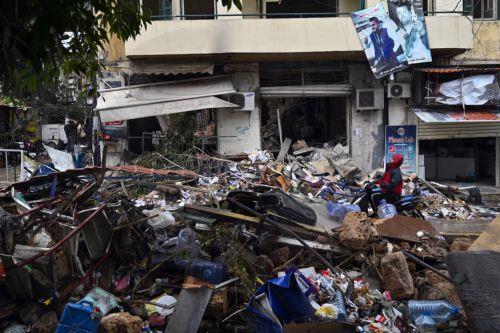 epa11728473 A man drives past a damaged building that was targeted by an Israeli airstrike in the Zuqaq al-Blat district in central Beirut, Lebanon, 19 November 2024. Lebanon's state-run National News Agency reported that two missiles struck the central district of Zuqaq al-Blat and according to the Lebanese Ministry of Health, five persons were killed and...