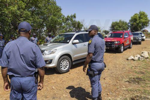 epa11728518 South Africa Police Service members stand near the entrance of a disused gold mine shaft in Stilfontein, around 150 kilometers south-west of Johannesburg, South Africa, 19 November 2024. A South African court has ordered the lifting of a police blockade of the abandoned gold mine, in which people are illegally located. Official rescue attempts...