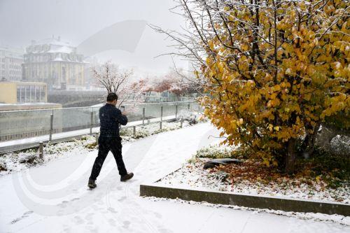 epa11733273 A person walks through a snow-covered road during snowfalls in Lausanne, Switzerland, 21 November 2024.  EPA/LAURENT GILLIERON